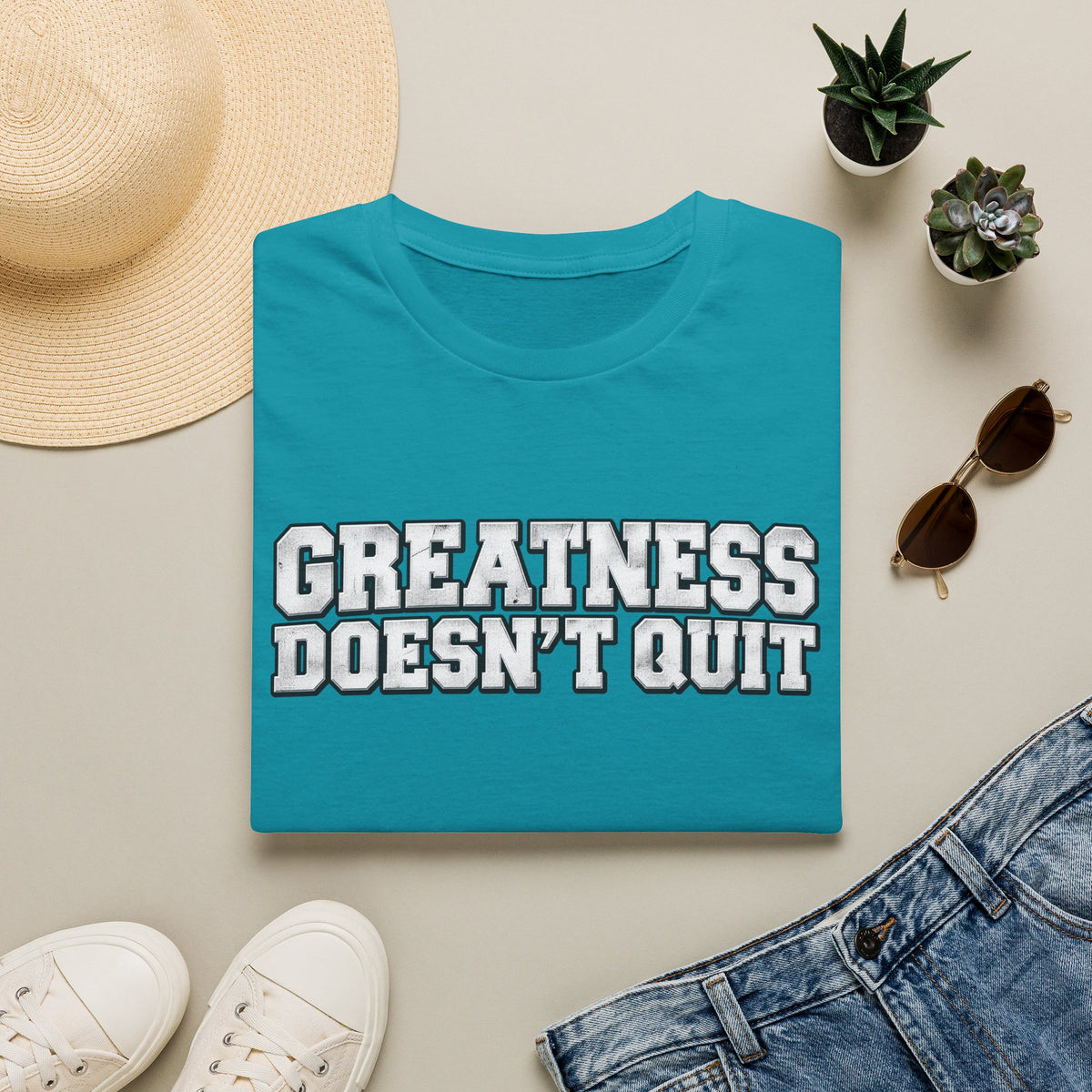 SatsandStripes.com Greatness Doesn’t Quit Softstyle® T-Shirt – Motivational Graphic Tee, Inspirational Shirt, Positive Mindset Gift for Men & Women Tropical Blue Folded